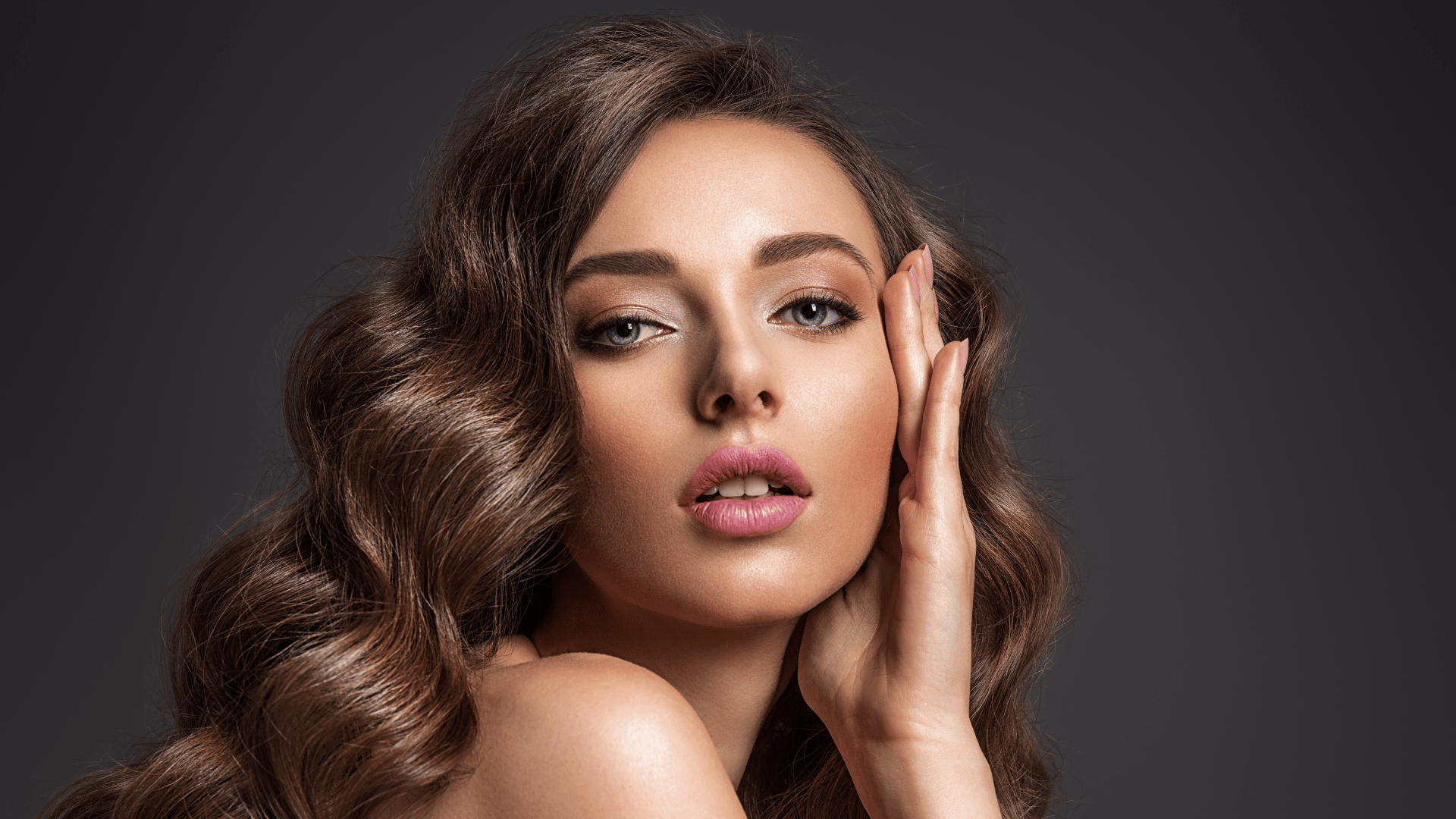 Woman with polished waves and luminous makeup